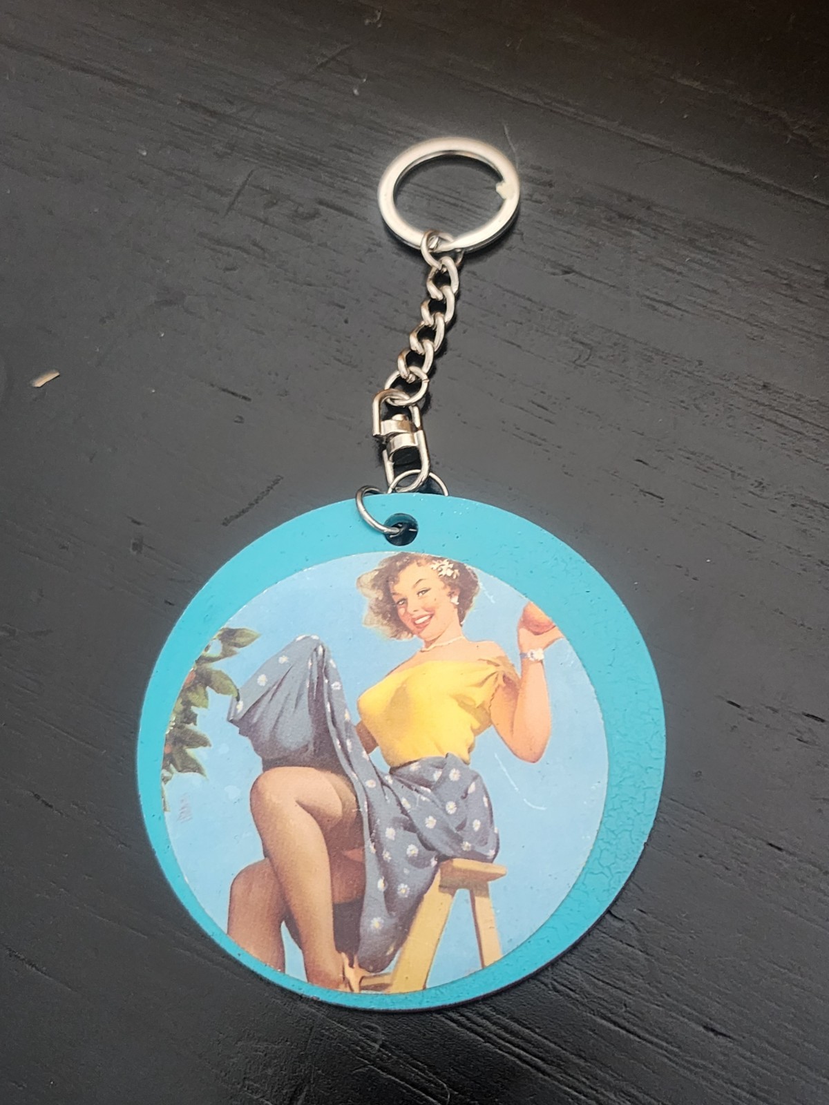 Pinup Girl Keychain featuring a vintage pinup girl image and silver keychain